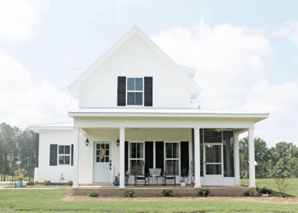 White farmhouse with black shutters