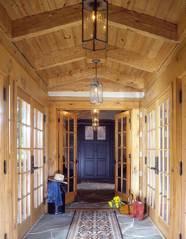 A wood paneled breezeway connects two separate housing compounds.