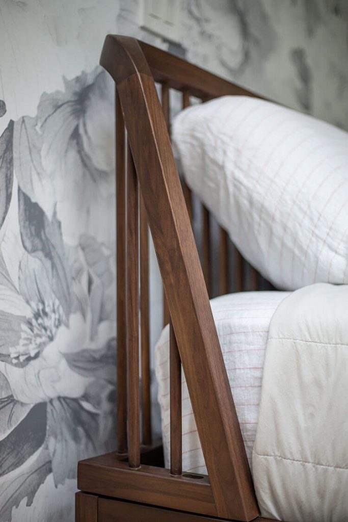 Bed corner with white pillow and sheets