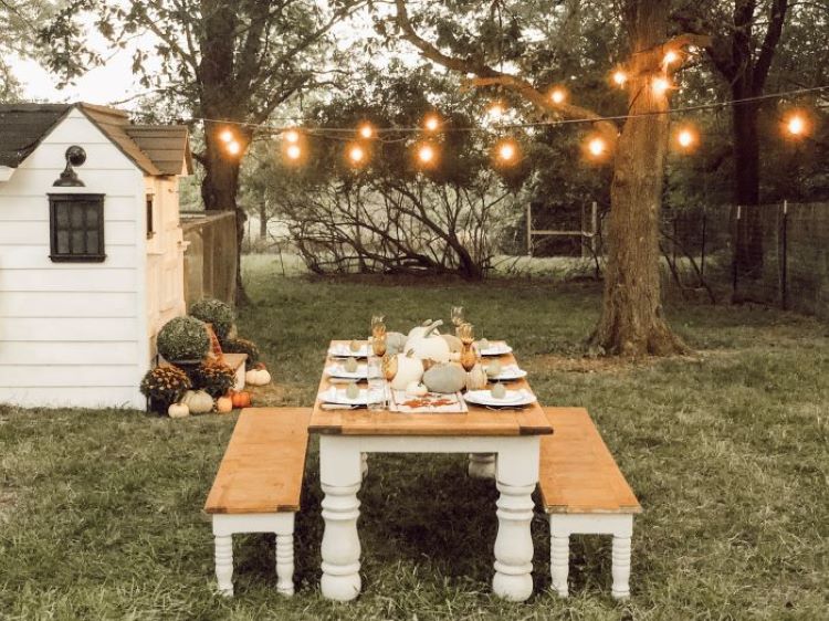 Outdoor fall dinner under lights