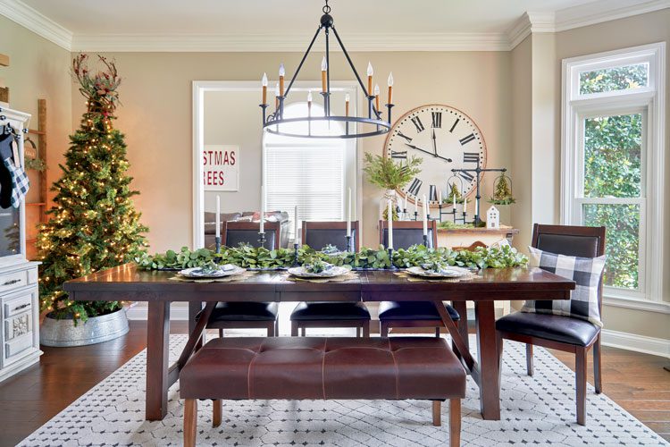 Jenna's family friendly Christmas house has a decorated, dark brown dining room table with a mixture of bench and chair seating.