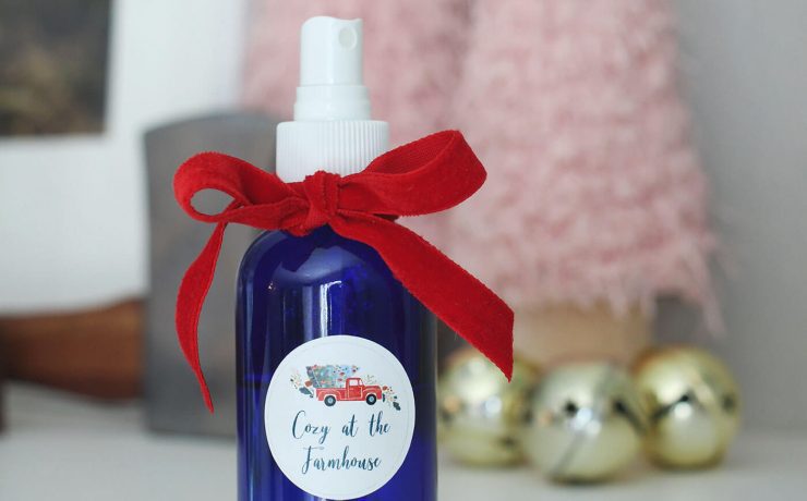 Glass spray bottle with farmhouse label on mantel