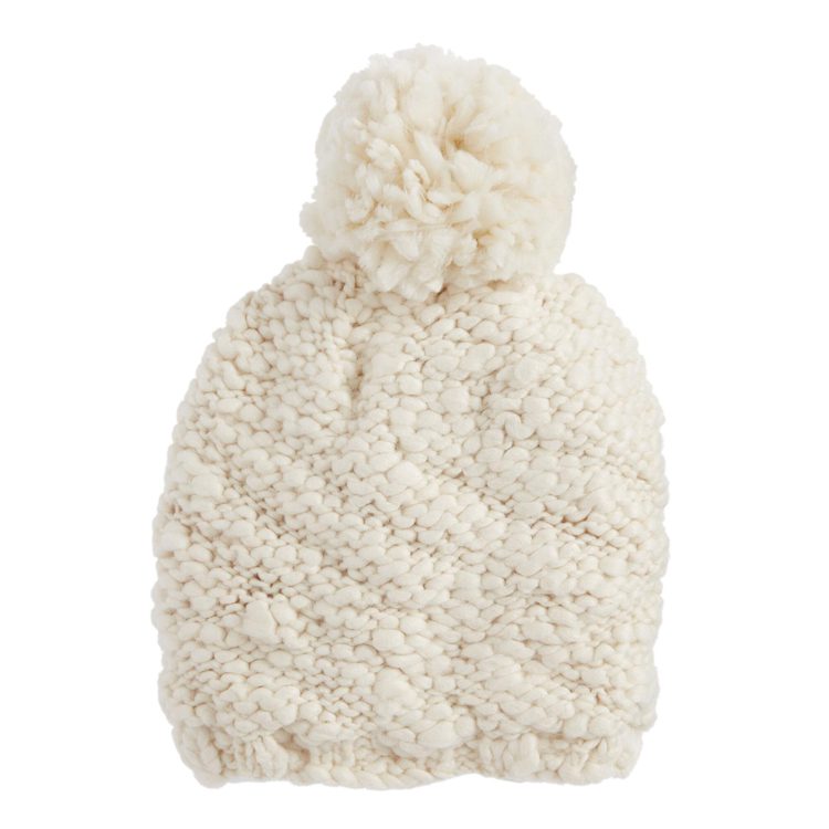 A staple in country winter fashion, this ivory chunky-knit beanie has a pom-pom on top.