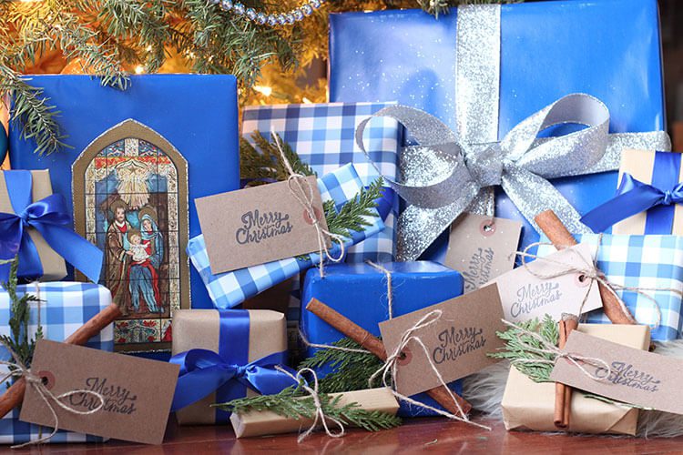 Blue Christmas gift wrap under a tree