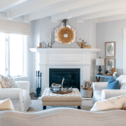 Modern farmhouse living with white walls and fireplace, a look that has been deep cleaned.