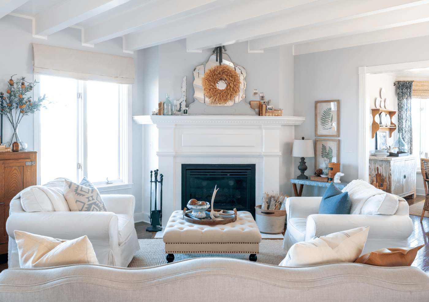 Modern farmhouse living with white walls and fireplace, a look that has been deep cleaned.