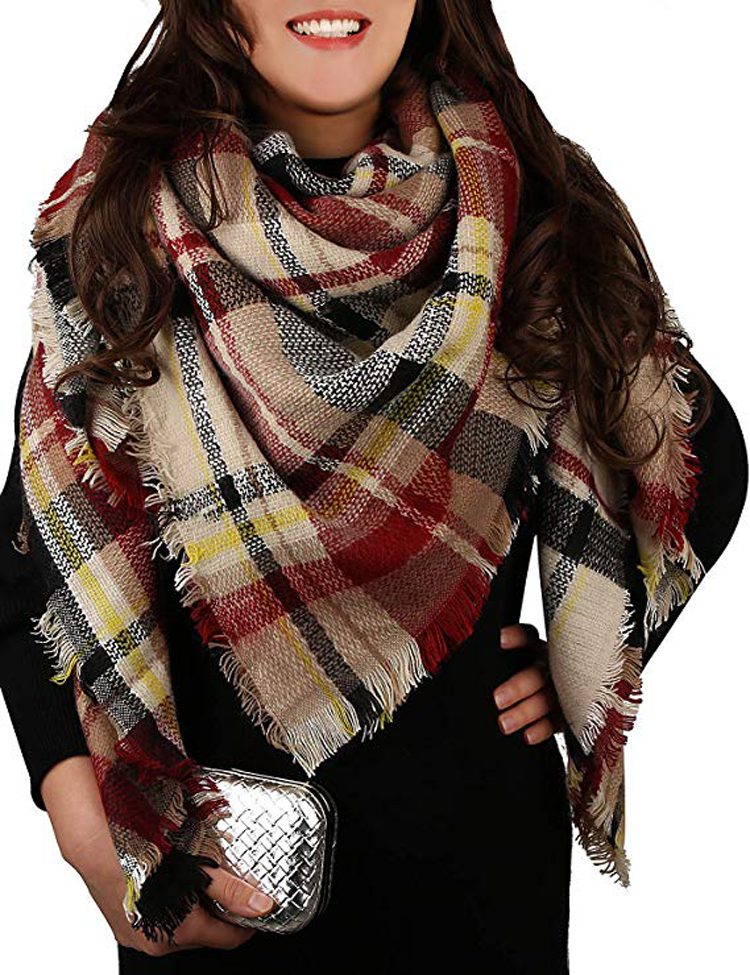 This large, plaid scarf has a small fringe along the edges and has the staple colors of farmhouse fashion—cream, beige, red, black and mustard.