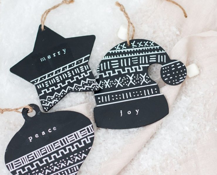 Three black and white mud cloth DIY ornaments with typewriter lettering and modern patterns.