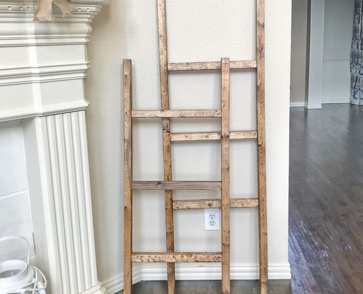 Two different sizes of wooden ladders propped up against a living room wall.
