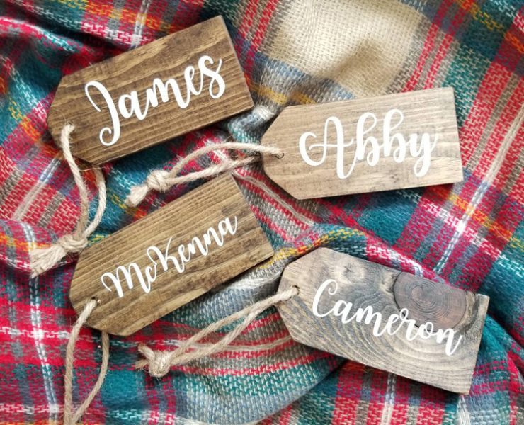 Wood name tags with painted white calligraphy are a farm-fresh Christmas decor idea.