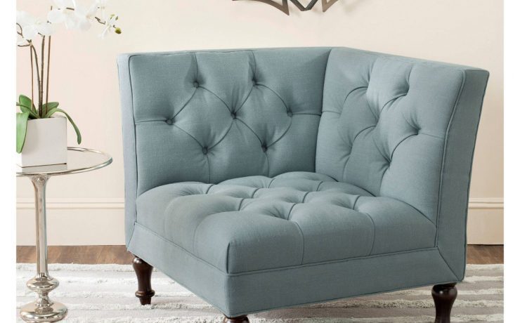 This piece of farmhouse furniture is a light blue, tufted accent chair.