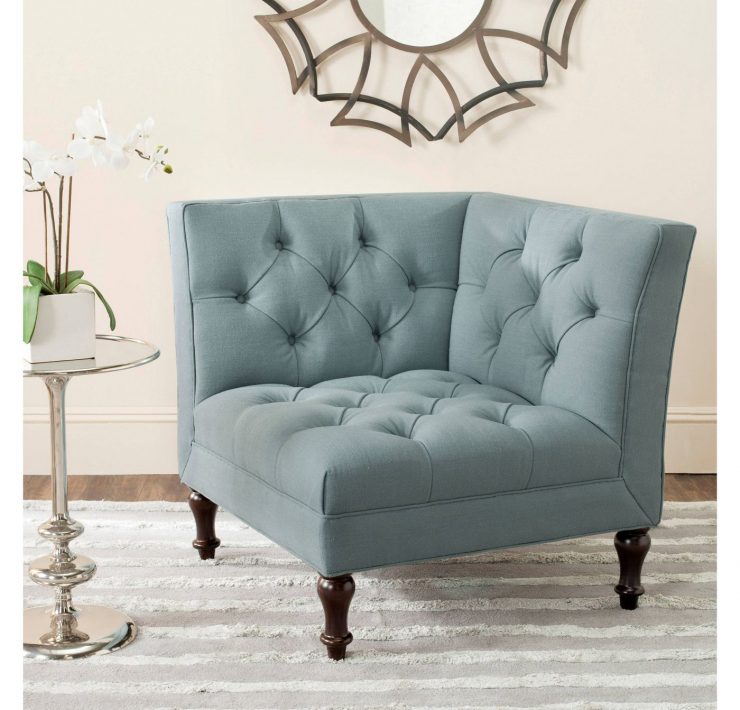 This piece of farmhouse furniture is a light blue, tufted accent chair.