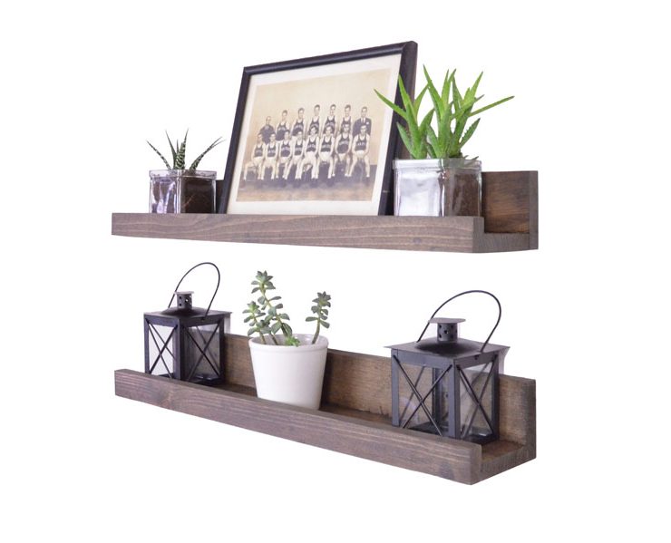 A pair of wooden, lipped wall shelves with an assortment of small decor.