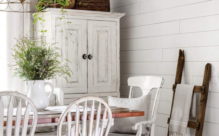 Vintage charm in dining room with exposed ceiling beams, shiplap and vintage furniture