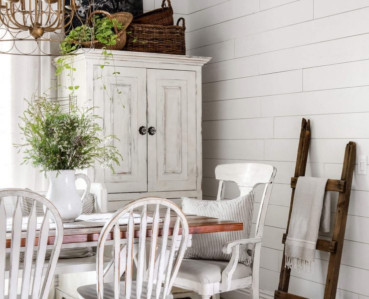 Vintage charm in dining room with exposed ceiling beams, shiplap and vintage furniture