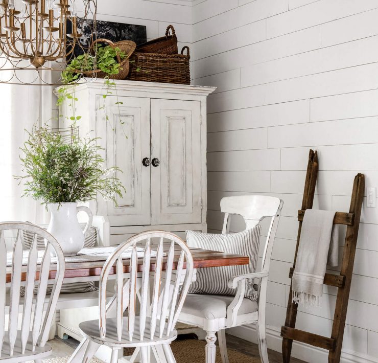 Vintage charm in dining room with exposed ceiling beams, shiplap and vintage furniture