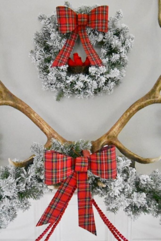 Cardinals appear inside the wreath of the Christmas mantel