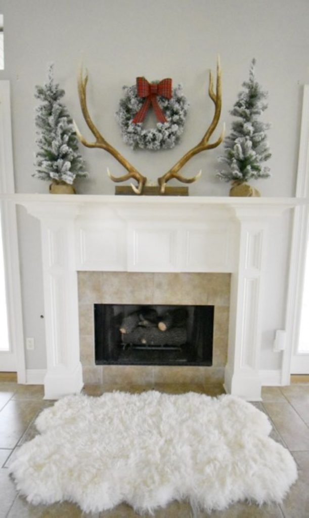 Beautiful mini trees add symmetry to the Christmas mantel