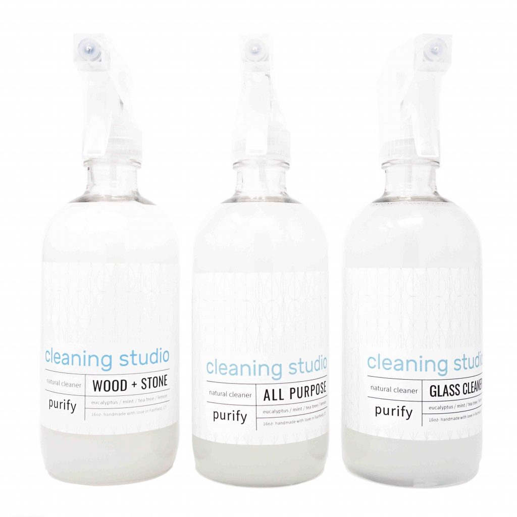 Three bottles of natural cleaning solutions—one for wood and stone, another for all purpose and another for glass, must-haves in furniture clean and repair kit.