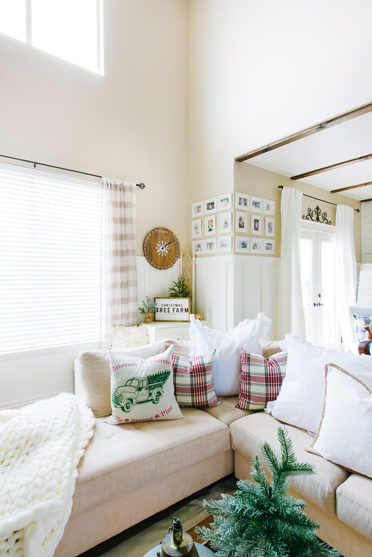 The corner of the off-white sectional sofa in the Utah farmhouse living room.