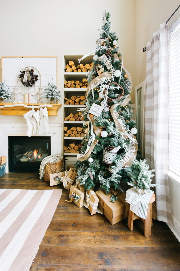 The Christmas tree decorated with tan and white ribbons, mini pails and natural garnishes.