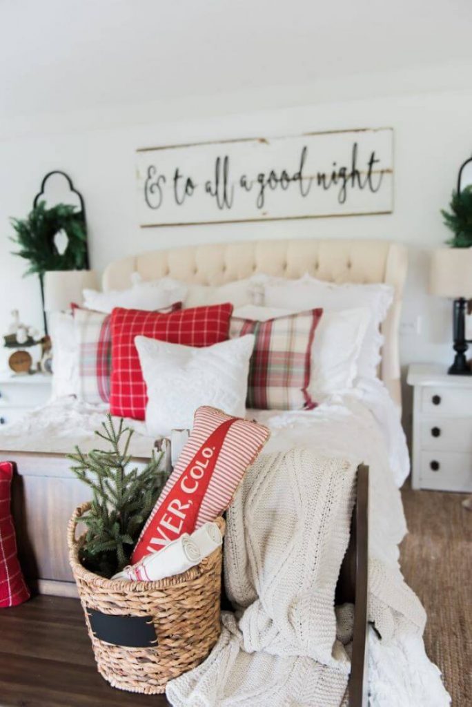 White bedroom with holly red throw pillows in paild and tartan