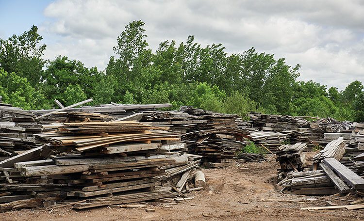 A lumber-yard full of reclaimed wood waiting to be processed.