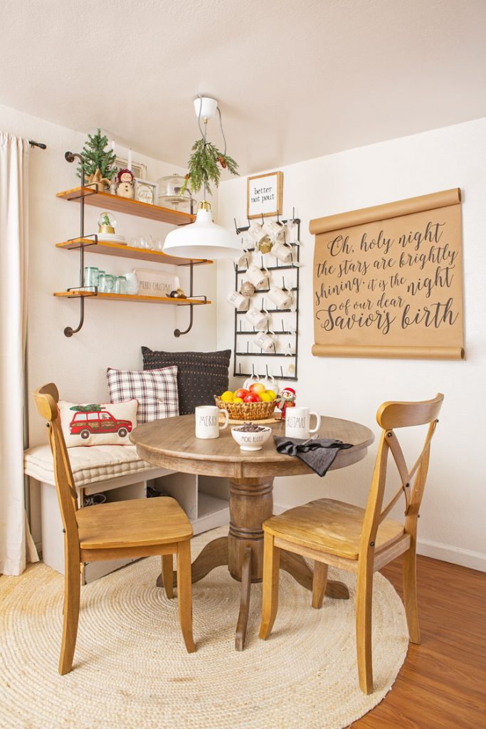 Small dining table in age corner with a brown paper, calligraphy banner hung on the wall.