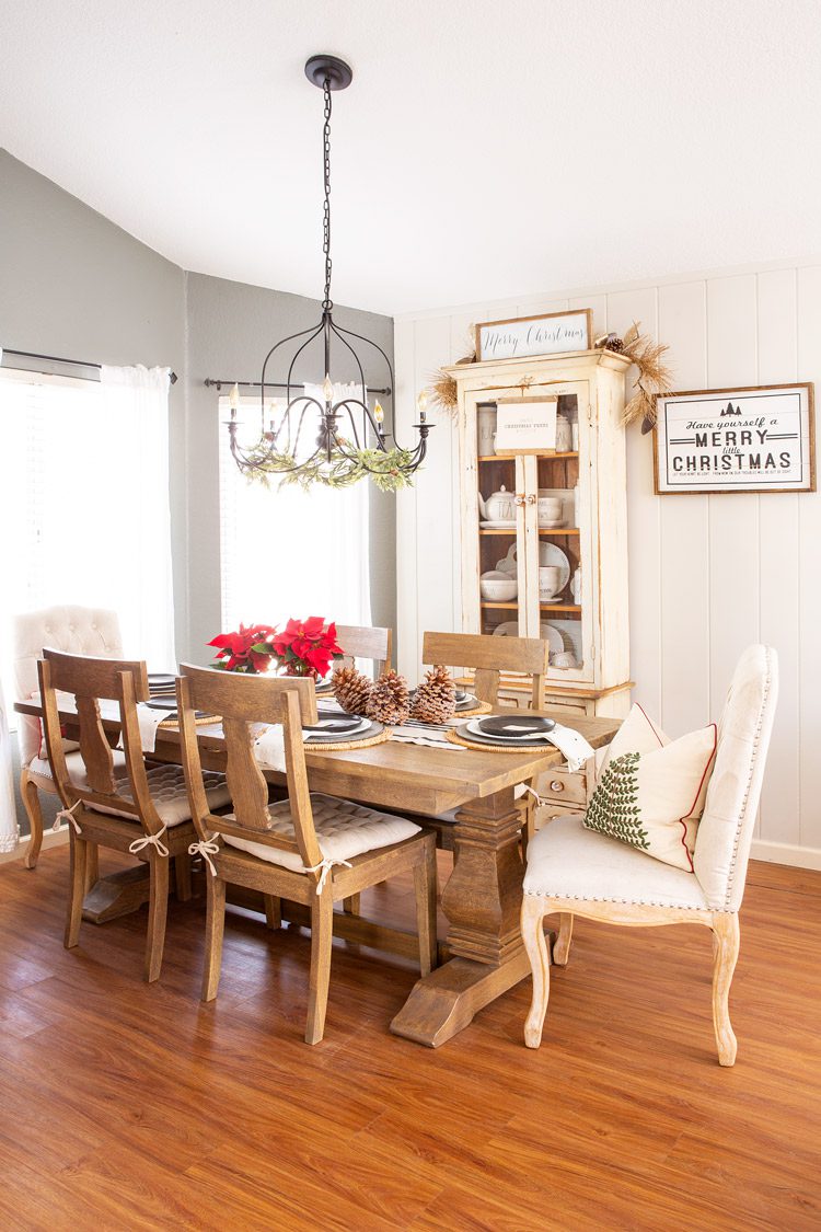 The Christmas cabin dining room with neutral colors accenting the wooden table.