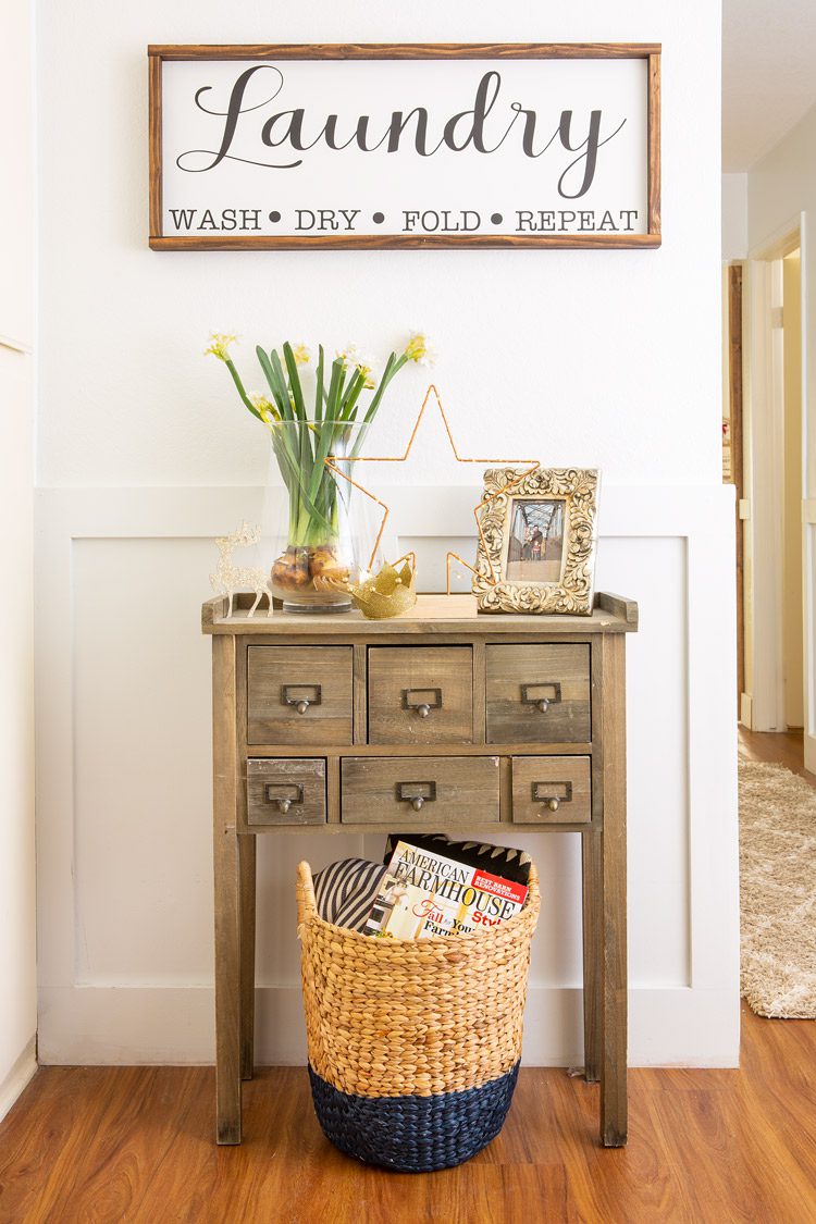Side table with six small drawers and a wooden laundry sign from Etsy.
