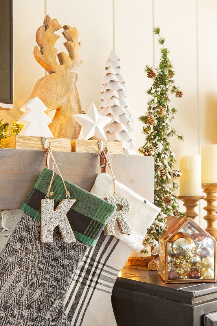 Christmas cabin stockings has sparkly, personalized letters hanging by each one.