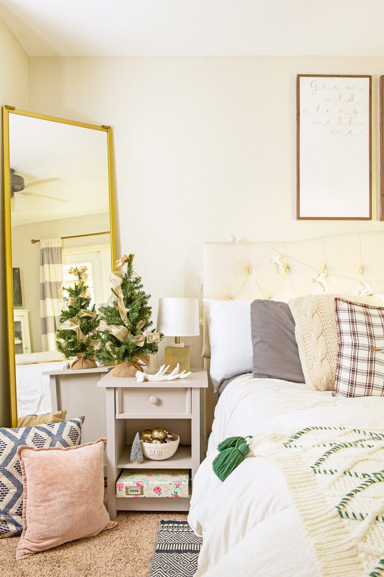 Christmas cabin bedroom with neutral colors and comfy pillows.