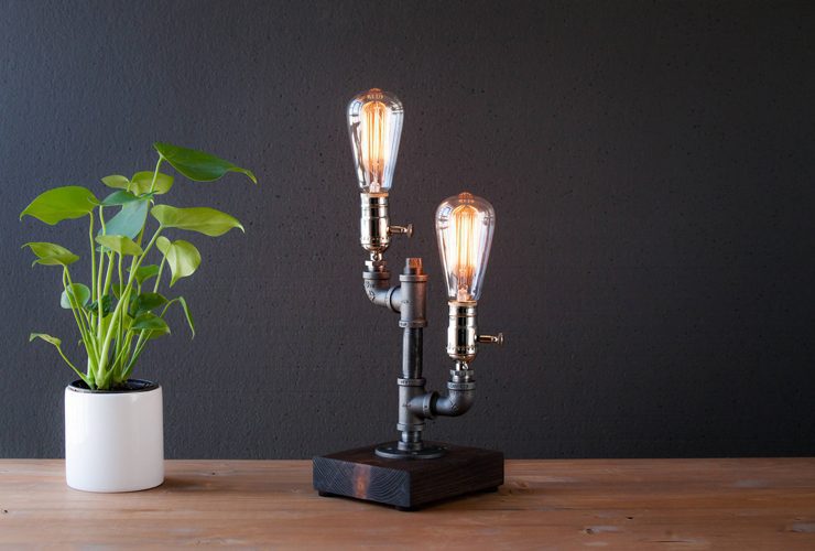 Industrial farmhouse lamp with two bare bulbs, great for budget-friendly decor.