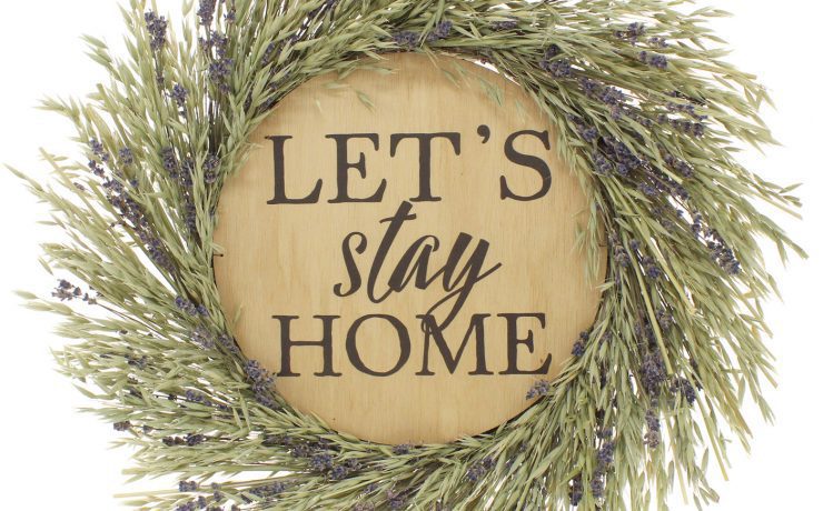 Lavender wreath framed "Let's Stay Home" wood sign in our gift guide.