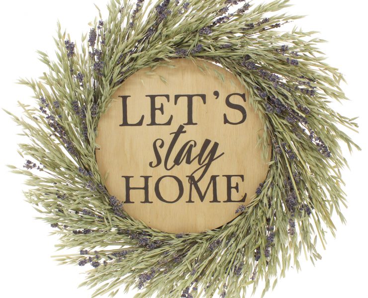 Lavender wreath framed "Let's Stay Home" wood sign in our gift guide.
