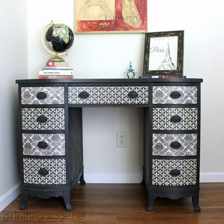 After picture: Black desk with black and white, French-patterned scrapbook paper pasted onto the drawers.