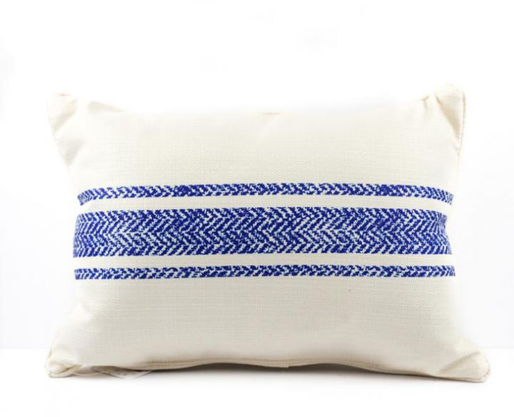 Off-white grain sack pillow with three patterned blue stripes down the middle.