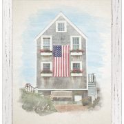 Watercolor portrait of an American farmhouse with a large American flag on the front.