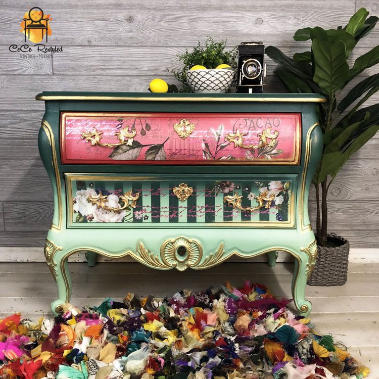 After picture of the off-white dresser, now painted green and pink with decorative gold decals, painted floral accents and blending techniques.