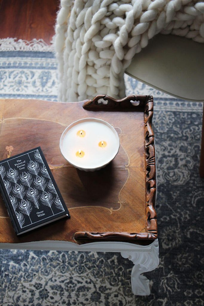 Vintage candle with book on top of table