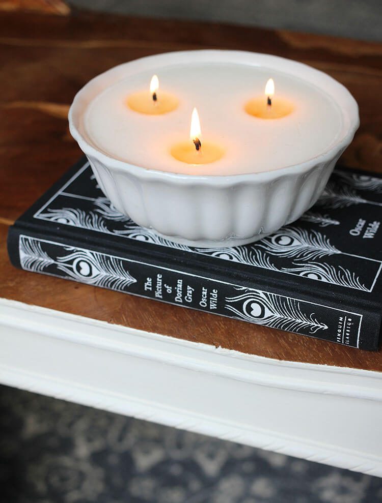 Vintage candle on top of classic book on coffee table