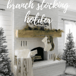 Jo's fireplace with her DIY stocking holder—a thin birch branch hanging from the mantel with faux fur stockings.