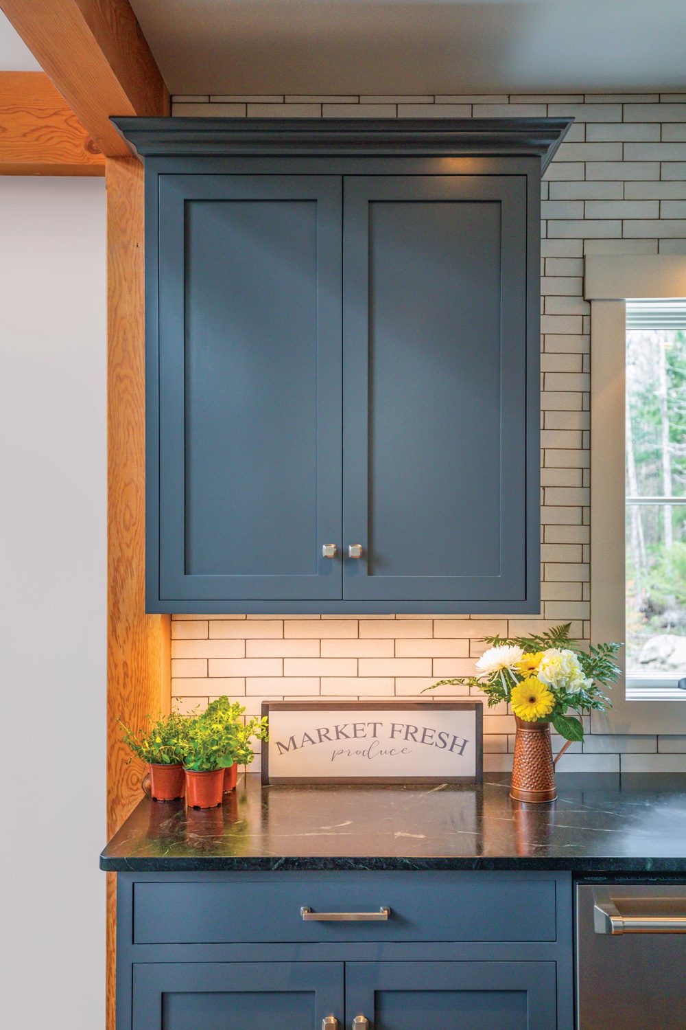 Kitchen cabinets with navy blue and subway tile