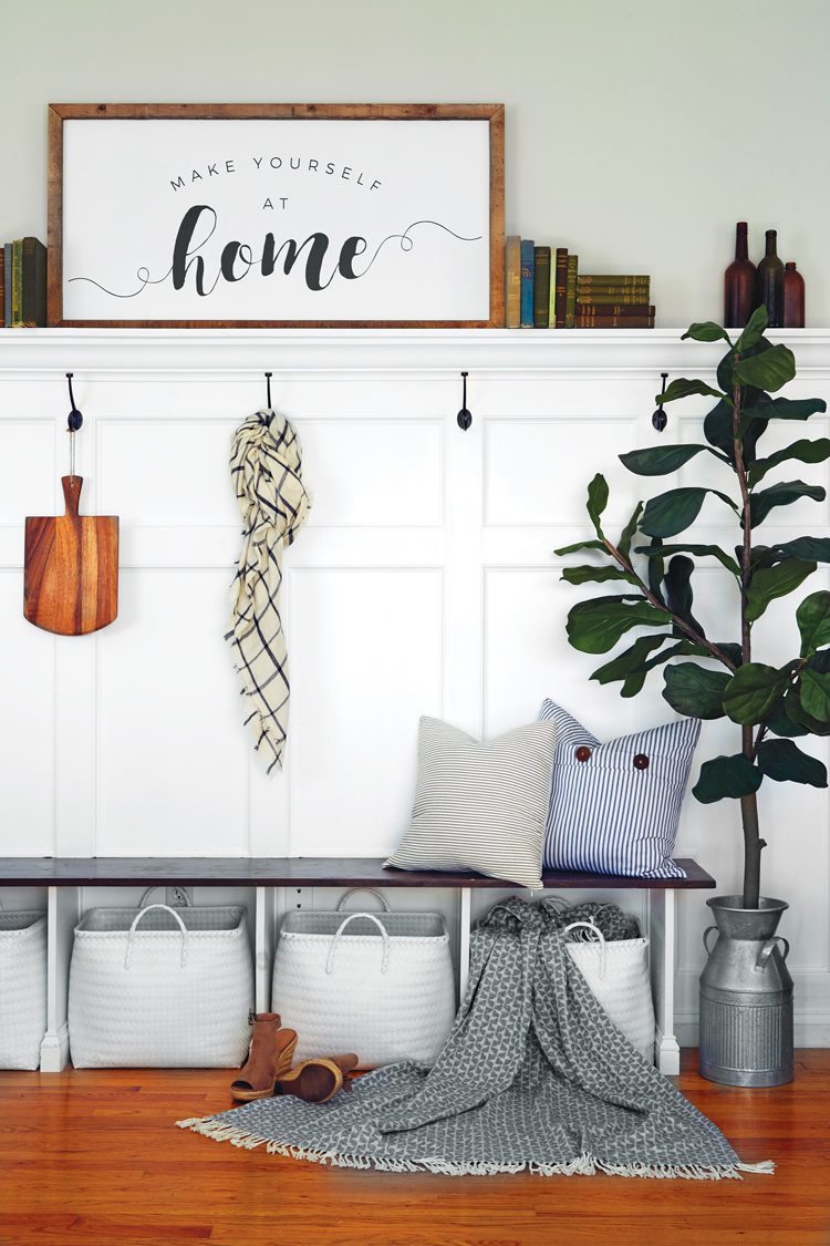 A mudroom-inspired area with an organization station of hooks, bins and shelves 