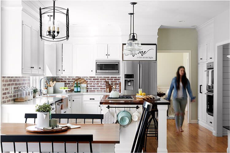 Kitchen with brick and white cabinets