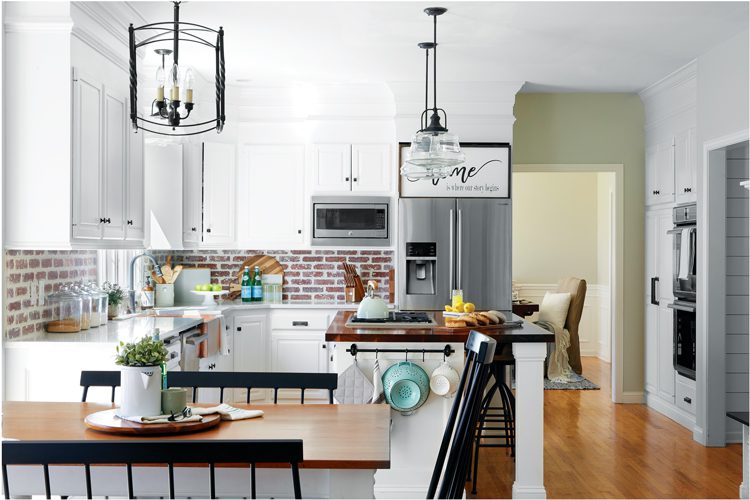 Exposed brick works as a modern farmhouse style backsplash in the kitchen of the modern home