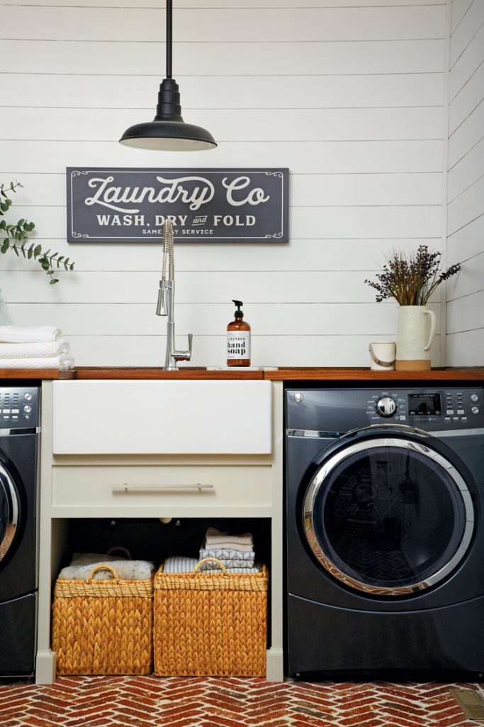 Laundry room with shiplap on the walls, farmhouse decor and brick flooring