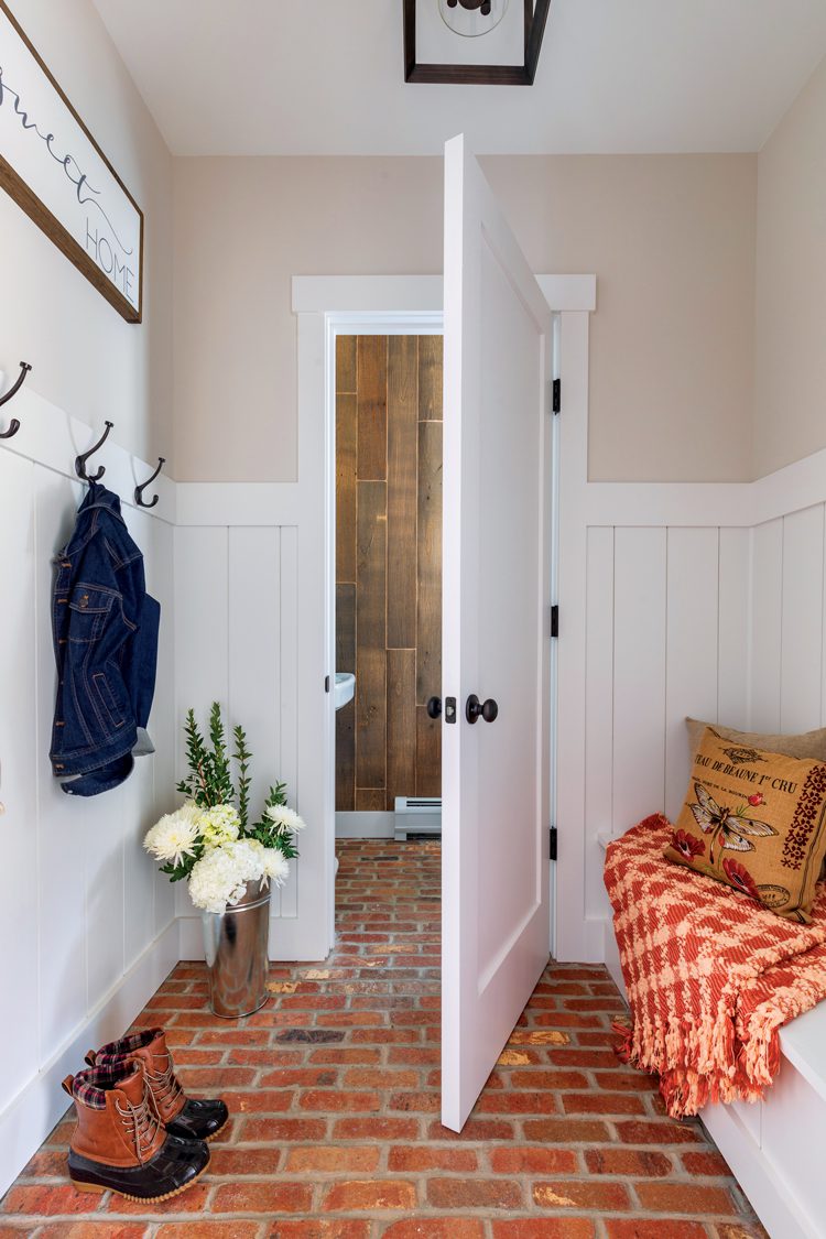 The brick mudroom in the Project House. The walls are white and the floor is exposed, bare brick from Cherokee Brick