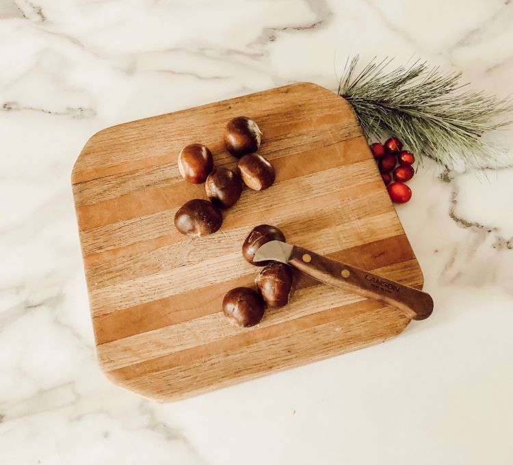 Roasted chestnits on a chopping board