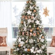 Silver and gold metallic Christmas tree with giant paper snowflakes